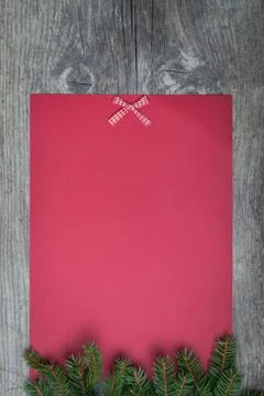 Pine tree with empty red paper sheet on old wooden background Stock Photos