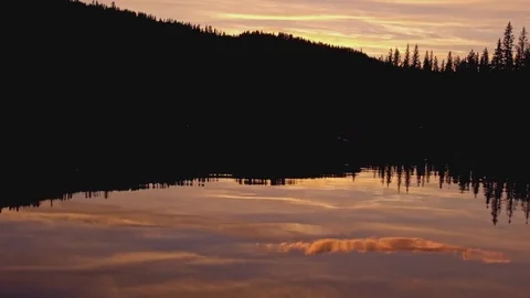 Pine tree forest silhouette and lake reflections at dusk sunset Anthony Lake in Stock-Footage 81844375