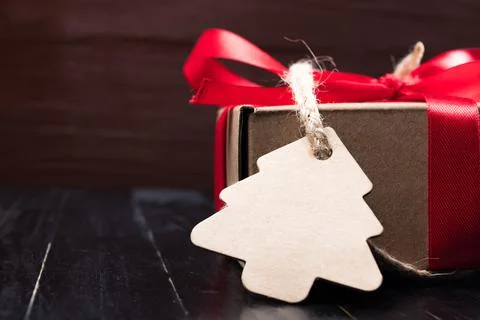 Pine tree label with twine attached on paper present. Stock Photos