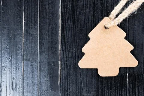 Pine tree label with twine attached on natural black table. Stock Photos