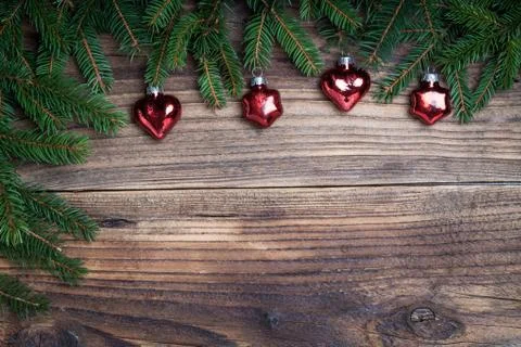Pine tree with red bauble on old wooden background Stock Photos