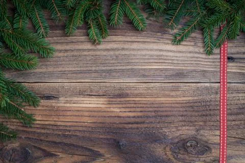 Pine tree with red ribbon on old wooden background Stock Photos