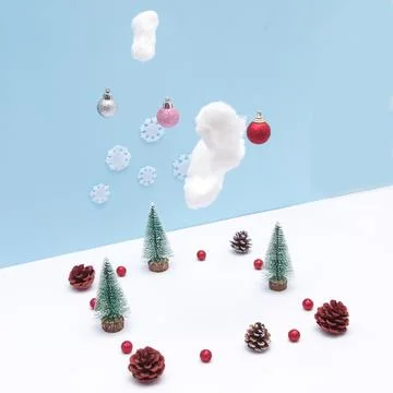 Pine tree in the snow with clouds from which New Year's decorations fall. Cop Stock Photos