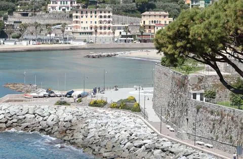 Pine trees and stone castle on seashore. Nature and structures of Europe, Italy Stock Photos