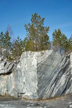 Pine trees on a marble quarry cliff at Ruskeala Mountain Park. Nature lands.. Stock Photos