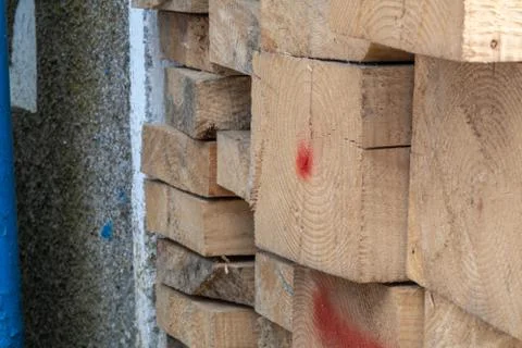 Pine wood timber stack of natural rough wooden boards on building site. Indus Stock Photos