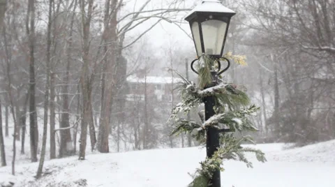 Pine-wrapped Lamp Light on a snowy day Video stock 34369108