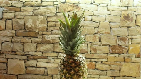 Pineapple accelerate and slow down rotating with brick background Stock Footage 141302390