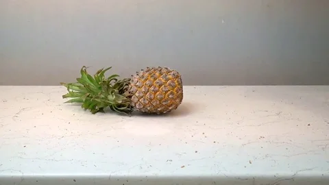 Pineapple and apple frozen in liquid nitrogen and broken Stock Footage 70282986