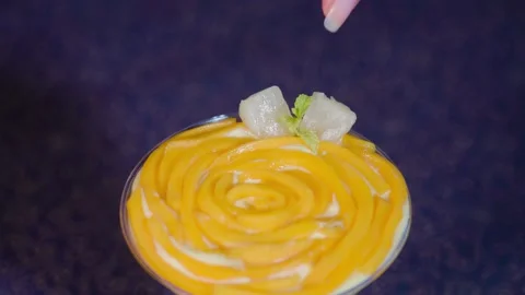 Pineapple and chocolate heart is put on the mango cake Stock Footage 160993576