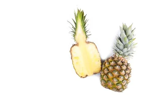 Pineapple and half of pineapple isolate on a white Stock Photos