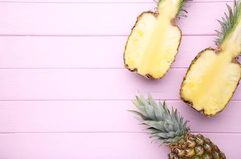 Pineapple and half of pineapple on a pink background Stock Photos