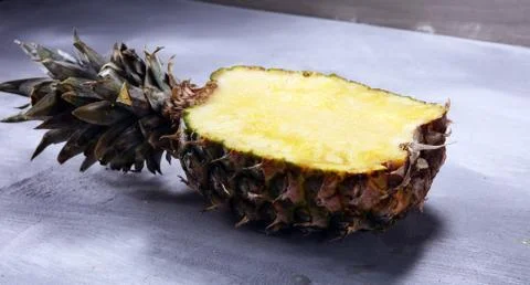 Pineapple and a half of pineapple ruit. vegan delicious snack on white stone  Stock Photos