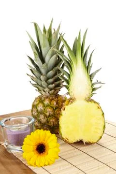 Pineapple and half on tabletop of acacia wood Stock Photos