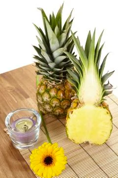 Pineapple and half on tabletop of acacia wood Stock Photos