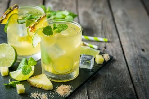 Pineapple and lime drink on rustic background Stock Photos