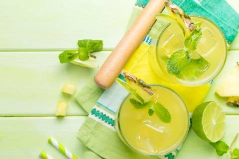 Pineapple and lime drink on rustic background Stock Photos
