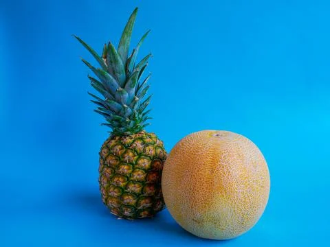 Pineapple and Melon with blue background Stock Photos