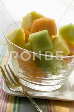 Pineapple And Melon Fruit Salad In A Glass Bowl