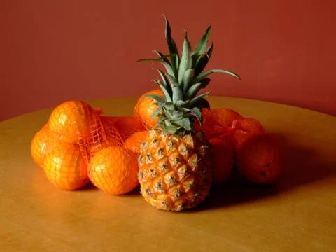Pineapple and oranges Stock Photos