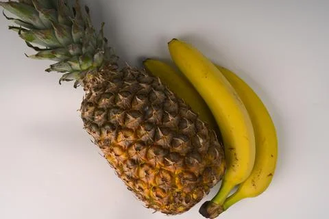 Pineapple and two bananas. Flatlay. Stock Photos