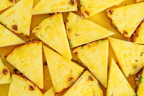 Pineapple background cut into triangles. Close up, top view. Stock Photos