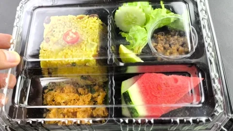  Pineapple Baked rice in plastic lunch box, indoor Chiangmai Thailand. Stock Footage 313457826