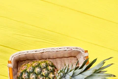 Pineapple in basket and text space. Stock Photos