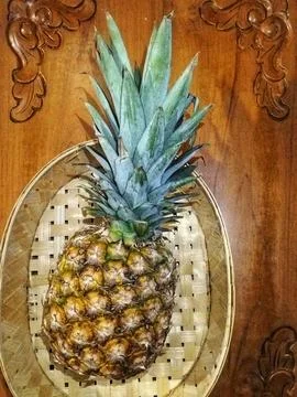 Pineapple in a basket  Stock Photos