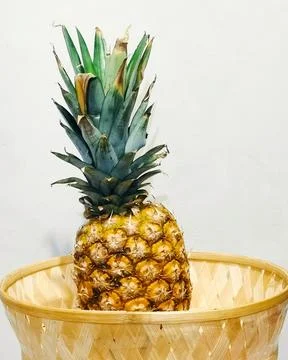 Pineapple in a basket  Stock Photos