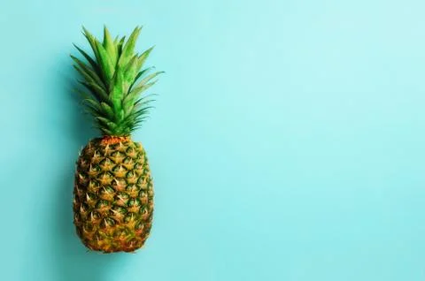 Pineapple on blue background. Top View. Copy Space. Pattern for minimal style Stock Photos