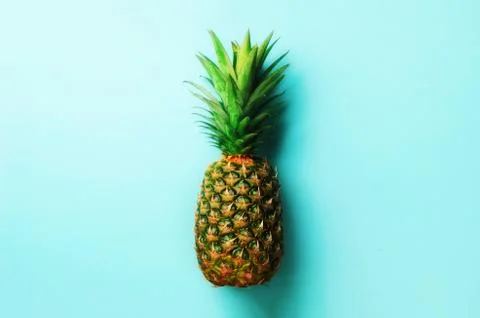 Pineapple on blue background. Top View. Copy Space. Pattern for minimal style Stock Photos
