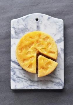 Pineapple cake on marble chopping board Stock Photos