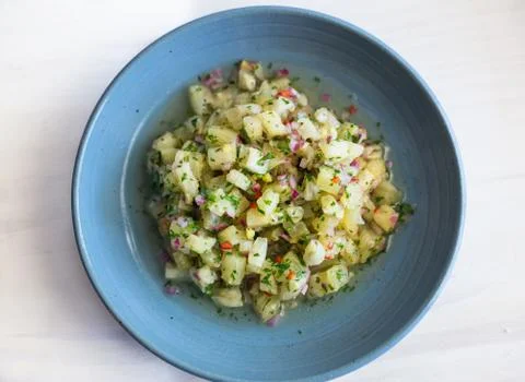 Pineapple ceviche on a white surface and blue dish Stock Photos