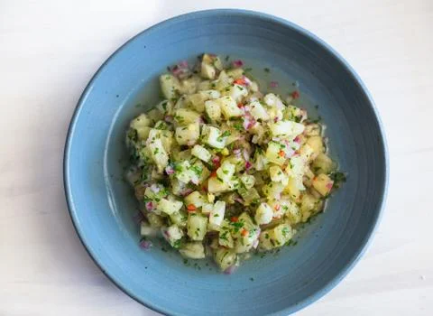 Pineapple ceviche on a white surface and blue dish Stock Photos