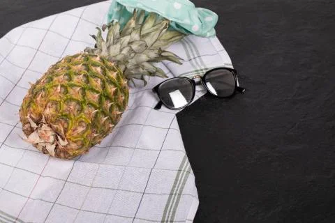 A pineapple on the checked kitchen towel Stock Photos