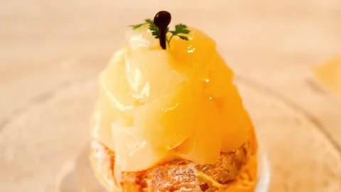 Pineapple choux cake, Puff cake filled with custard cream and pineapple in syrup Stock Footage 308122068