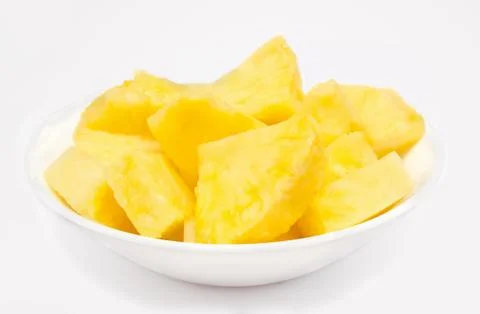 Pineapple chunks in the bowl isolated Stock Photos