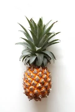 A pineapple closeup on the white background. Stock Photos