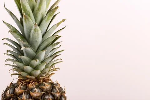 Pineapple closeup on a yellow background. Summer mood, copy space. Stock Photos