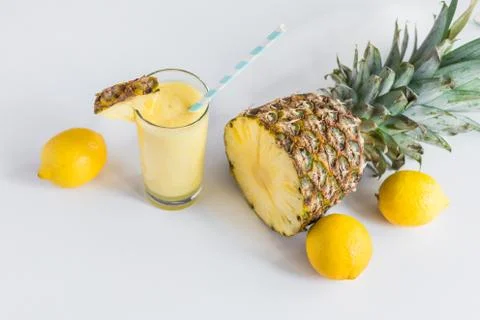 Pineapple cocktail with lemons and pineapple on white background Stock Photos