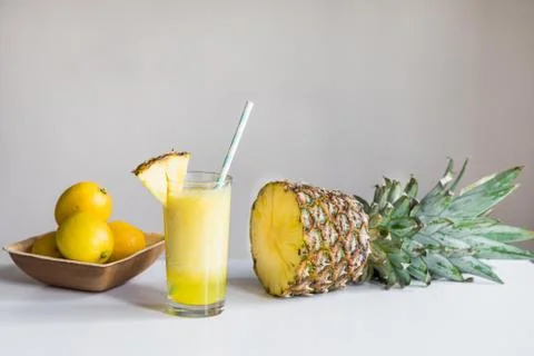 Pineapple cocktail, pineapple and lemons on white background Stock Photos