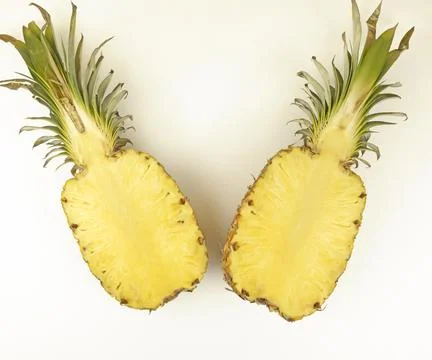 Pineapple cut in half. Two halves of a pineapple on a white background, top view Stock Photos