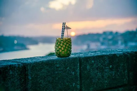 Pineapple Drink on a Seaside Stone Wall at Sunset Stock Photos