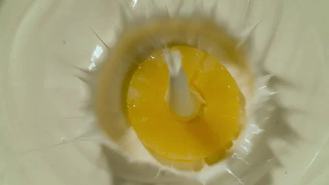 Pineapple falling in yogurt slow motion top view Stock Footage 124798411