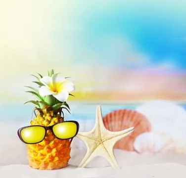 Pineapple with flower and seashell in the beach. Summer concept. Stock Photos
