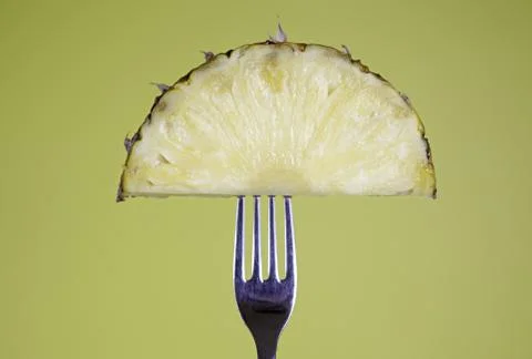 Pineapple on the fork Stock Photos