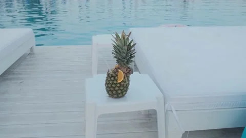 Pineapple in the form of a cocktail on the background of the pool. Summer 動画素材 136100748