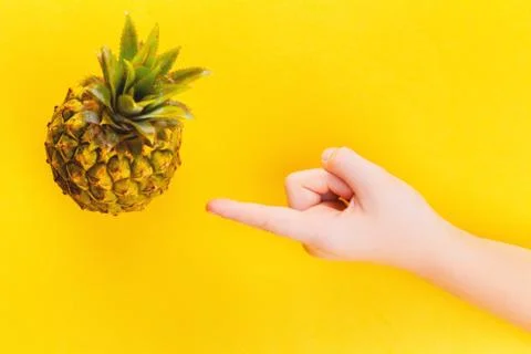 Pineapple in a frame on summer yellow background Stock Photos