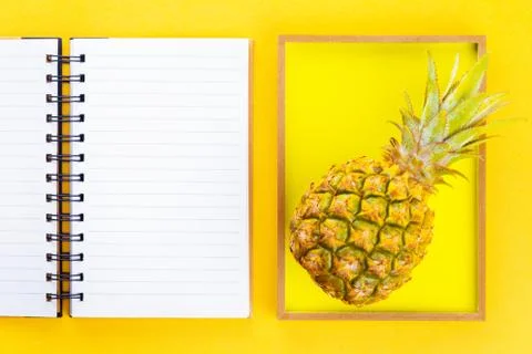 Pineapple in a frame on summer yellow background Stock Photos